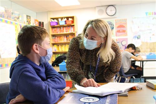 Teacher speaking with student